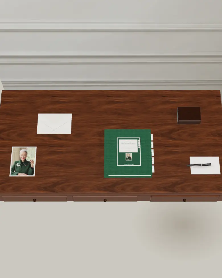 Maureen's walnut writing desk in morning light: a photograph, an envelope, a green binder, a small walnut box and a fountain pen.